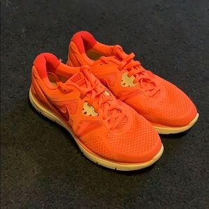 Bright orange. Nike sneakers. woman’s